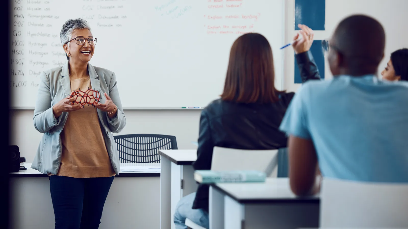 A teacher explaining a concept to students in a classroom