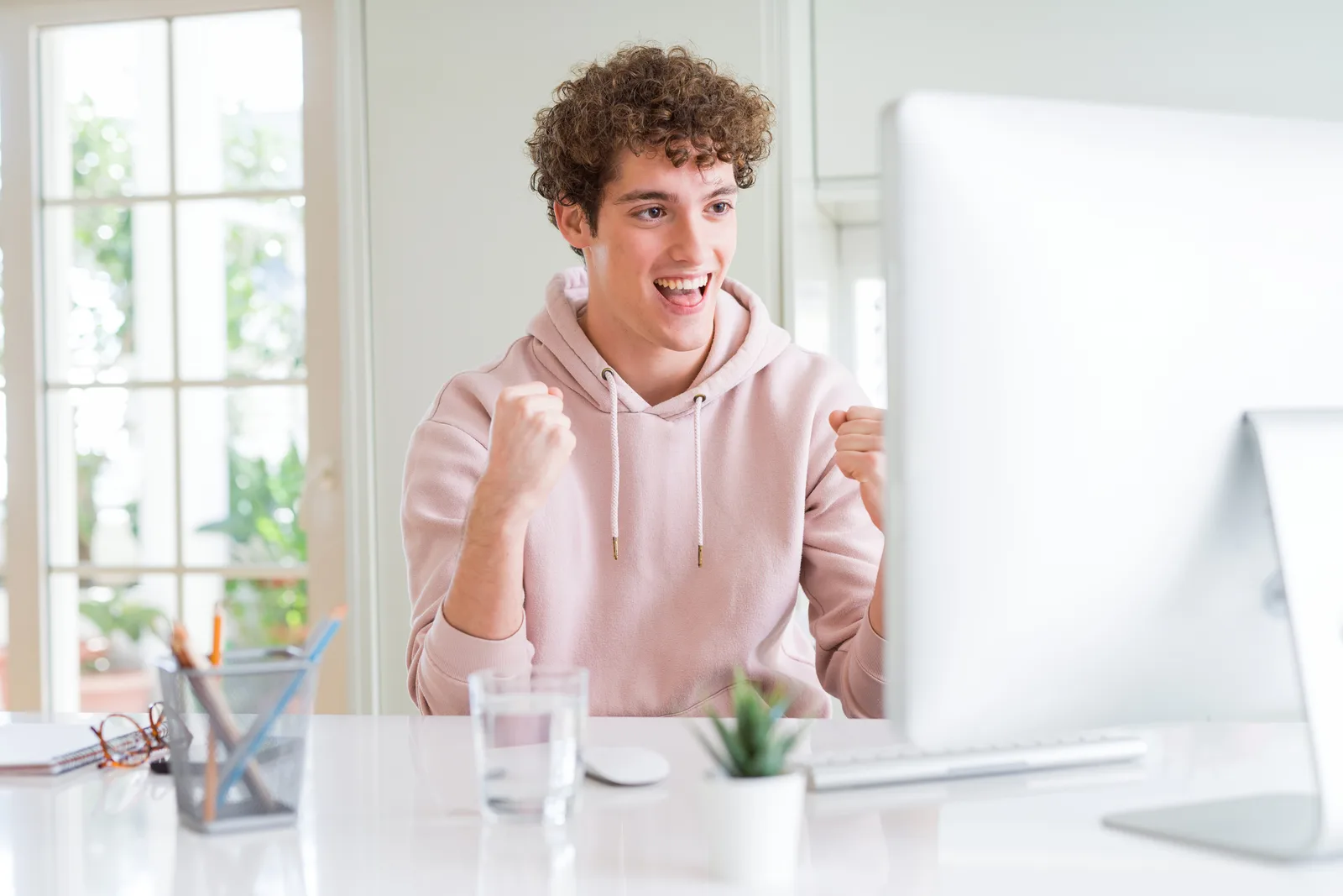 A student working at his computer at home